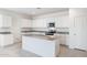 Modern kitchen with white cabinets, granite countertops, and island at 4930 S 105Th Ln, Tolleson, AZ 85353