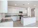 Modern kitchen with white cabinets, granite countertops and island at 4930 S 105Th Ln, Tolleson, AZ 85353