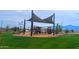Community playground with shade structure and play equipment at 4930 S 105Th Ln, Tolleson, AZ 85353