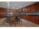 Kitchen with dark wood cabinets, granite countertops, and island seating at 5330 W Coles Rd, Laveen, AZ 85339