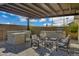 Covered patio with outdoor kitchen and comfortable seating at 5651 E Sierra Morena St, Mesa, AZ 85215