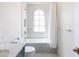 Modern bathroom with marble finishes, soaking tub, and arched window at 6140 E Calle Tuberia --, Scottsdale, AZ 85251