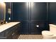 Chic powder room, dark blue walls, geometric tile floor at 6140 E Calle Tuberia --, Scottsdale, AZ 85251
