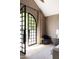 Bright bedroom with arched French doors opening to backyard at 6140 E Calle Tuberia --, Scottsdale, AZ 85251