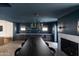 Modern dining room with dark wood table, built-in bar, and fireplace at 6140 E Calle Tuberia --, Scottsdale, AZ 85251