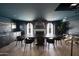 Sophisticated dining room features a long table, dark walls, and a chandelier at 6140 E Calle Tuberia --, Scottsdale, AZ 85251