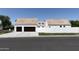 Two-car garage with dark brown doors and a stone driveway at 6140 E Calle Tuberia --, Scottsdale, AZ 85251