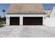 Two-car garage featuring dark brown doors and a stone paved driveway at 6140 E Calle Tuberia --, Scottsdale, AZ 85251