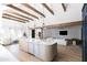 Open concept kitchen and living space with a large island and white sofas at 6140 E Calle Tuberia --, Scottsdale, AZ 85251