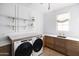 Laundry room with Whirlpool appliances and wood cabinets at 6140 E Calle Tuberia --, Scottsdale, AZ 85251