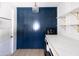 Bright laundry room with blue cabinetry and marble counters at 6140 E Calle Tuberia --, Scottsdale, AZ 85251