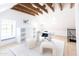 Bright home office boasts wood beams, built-in shelving, and a marble desk at 6140 E Calle Tuberia --, Scottsdale, AZ 85251
