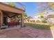 Covered patio with seating area and a large grassy backyard at 6216 W Morrow Dr, Glendale, AZ 85308