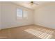 Bright bedroom with large window and neutral carpeting at 6216 W Morrow Dr, Glendale, AZ 85308