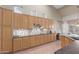 Well-lit kitchen with wood cabinets, sleek countertops, tile backsplash, and modern appliances at 6216 W Morrow Dr, Glendale, AZ 85308