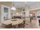Open-concept living space shows kitchen, living room, and dining area, blending together in a harmonious flow at 6216 W Morrow Dr, Glendale, AZ 85308