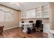 Home office with L-shaped desk and built-in shelves at 6216 W Morrow Dr, Glendale, AZ 85308