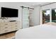 Bright main bedroom with sliding door to backyard, flat screen TV, and modern dresser at 6411 E Presidio Rd, Scottsdale, AZ 85254