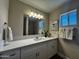 Bright bathroom featuring modern vanity with a quartz countertop and stylish fixtures at 8144 E Kilarea Ave, Mesa, AZ 85209