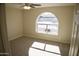 Spacious bedroom with large arched window at 8144 E Kilarea Ave, Mesa, AZ 85209