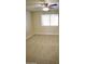 Bright bedroom with carpeted floor, ceiling fan, and large window at 8144 E Kilarea Ave, Mesa, AZ 85209