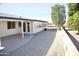 Home exterior showcasing a covered patio and landscaping at 8144 E Kilarea Ave, Mesa, AZ 85209