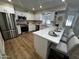 Modern kitchen featuring stainless steel appliances, white cabinets, and a breakfast bar with seating at 8144 E Kilarea Ave, Mesa, AZ 85209