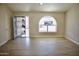 Bright living room with wood-look floors and an arched window at 8144 E Kilarea Ave, Mesa, AZ 85209