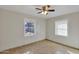 Bedroom features tile floor, neutral paint, ceiling fan and view from two windows at 914 N Cameron Ave, Casa Grande, AZ 85122