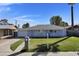 Charming single-story home with a well-manicured lawn, blue exterior and a driveway leading to an attached garage at 914 N Cameron Ave, Casa Grande, AZ 85122