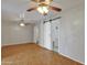 Spacious bedroom featuring parquet floors, multiple ceiling fans, and a sliding barn door at 914 N Cameron Ave, Casa Grande, AZ 85122