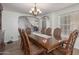 Formal dining room with a large table, chandelier, and hardwood floors at 9915 N 57Th Ln, Glendale, AZ 85302