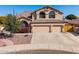 Two-story house with three-car garage and landscaping at 9915 N 57Th Ln, Glendale, AZ 85302