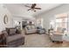 Living room features comfortable seating and a stone fireplace at 9915 N 57Th Ln, Glendale, AZ 85302