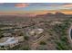 Aerial view of home nestled in a mountainside community at sunset at 10031 N Palisades Blvd, Fountain Hills, AZ 85268