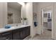 Modern bathroom with dark vanity, quartz countertop, and access to closet at 10031 N Palisades Blvd, Fountain Hills, AZ 85268