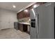 Laundry room with KitchenAid refrigerator, washer, dryer, and cabinets at 10031 N Palisades Blvd, Fountain Hills, AZ 85268