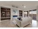 Bright living room with a fireplace, built-in shelving, and sliding glass doors leading to a balcony at 10031 N Palisades Blvd, Fountain Hills, AZ 85268