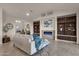 Spacious living room with a fireplace, built-in shelving, and large windows at 10031 N Palisades Blvd, Fountain Hills, AZ 85268