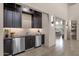 Modern wet bar with dark cabinetry, granite countertops, and stainless steel appliances at 10031 N Palisades Blvd, Fountain Hills, AZ 85268