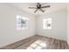 Well-lit bedroom with wood-look floors and ceiling fan at 1018 S Butte Ave, Tempe, AZ 85281