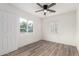 Bright bedroom features wood-look floors, ceiling fan, and lots of natural light at 1018 S Butte Ave, Tempe, AZ 85281