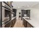 Modern kitchen with dark cabinetry, quartz countertops, and a large island at 1018 S Butte Ave, Tempe, AZ 85281