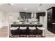 Contemporary kitchen island with sleek quartz countertop, stylish seating, and modern black cabinets at 1018 S Butte Ave, Tempe, AZ 85281