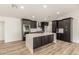 Modern kitchen with dark cabinetry, quartz countertops, and stainless steel appliances at 1018 S Butte Ave, Tempe, AZ 85281