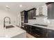 Modern kitchen with dark cabinetry, quartz countertops, and stainless steel appliances at 1018 S Butte Ave, Tempe, AZ 85281