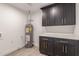 Bright laundry room with dark cabinetry and new water heater at 1018 S Butte Ave, Tempe, AZ 85281