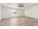 Spacious living room with wood-look floors, neutral walls, and a ceiling fan for added comfort at 1018 S Butte Ave, Tempe, AZ 85281