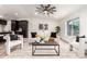 Bright living room featuring a modern ceiling fan, neutral furniture, and views to the exterior at 1018 S Butte Ave, Tempe, AZ 85281