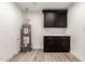 A utility room with black cabinetry, a countertop, and a water heater at 1018 S Butte Ave, Tempe, AZ 85281